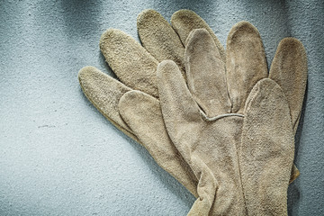 Safety gloves on concrete surface construction concept
