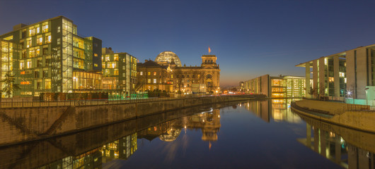 Fototapeta na wymiar BERLIN, GERMANY, FEBRUARY - 16, 2017: Panorama of modern Government buildings and Reichstag over the Spree river in evening dusk.