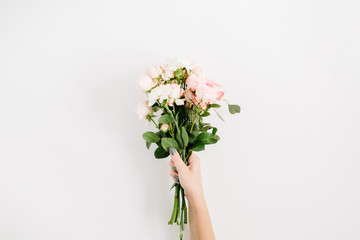 Beautiful pink rose flower bouquet in girls hand isolated on white background. Flat lay, top view. Floral composition