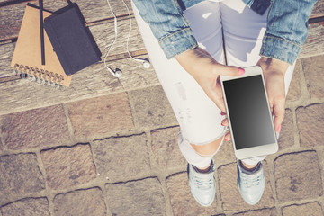 Woman using modern white smartphone. Top view