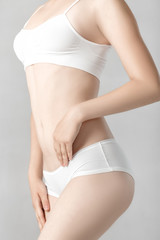 Fototapeta na wymiar Perfect sports body of woman in white lingerie. Slim female shape