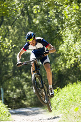 Fototapeta premium Handsome young man cycling in the mountain.