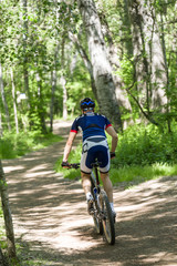 Naklejka premium Handsome young man cycling in the mountain.