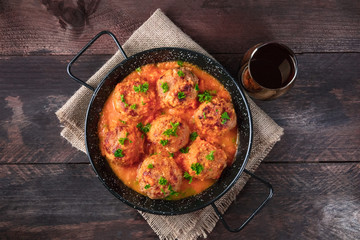Pan of meatballs in tomato sauce, overhead photo with copyspace