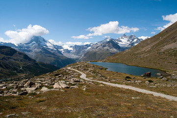 Lake and stone pointed mountains in the Swiss Alps.