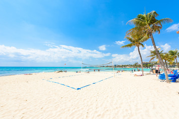 Playa del Carmen - relaxing on chair at paradise beach and city at caribbean coast of Quintana Roo,...