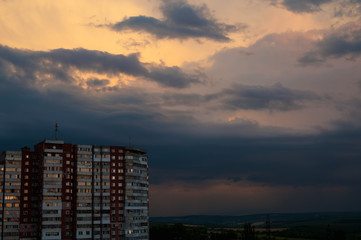 Fantastic sunset background, focus on city buildings