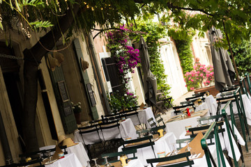 Little old rustic restaurant in France - tables outside under the tree 