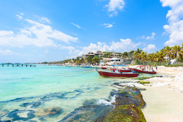 Playa del Carmen - relaxing on chair at paradise beach and city at caribbean coast of Quintana Roo, Mexico - obrazy, fototapety, plakaty