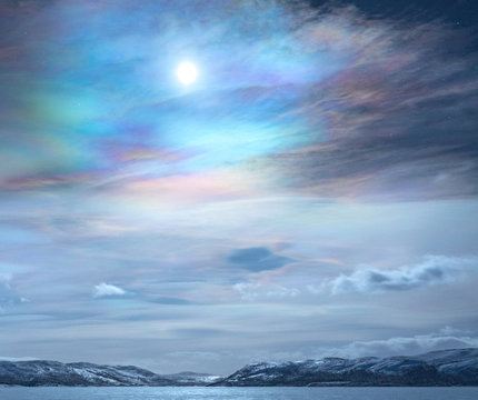 Scenic view of frozen lake against polar stratospheric clouds 