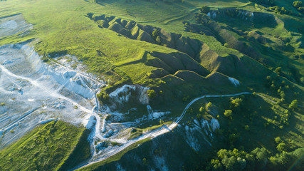 View  from the top on the chalky quarry and a beautiful landscape with meadows, hills and trees
