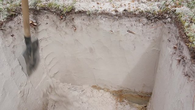 Cleaning the walls of the excavation with a shovel