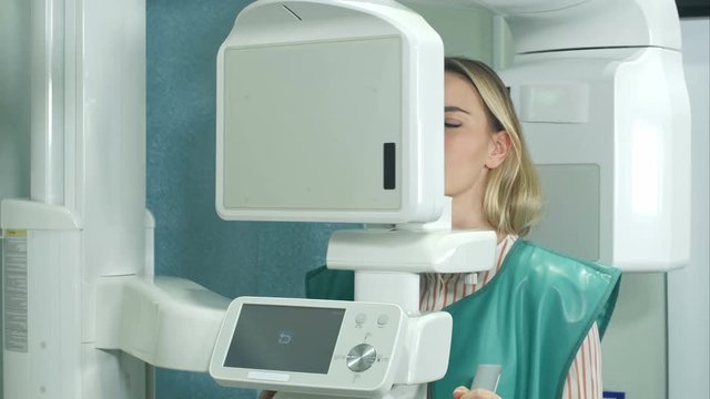 Female patient undergoing tests on dental X-Ray scanner