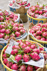 Dragon fruits arranging into bamboo basket