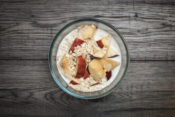 Flakes on bowl with milk and apple.