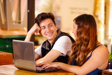 Smiling happy couple at the bar spending time together