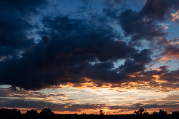 Warm orange sky and cold blue clouds