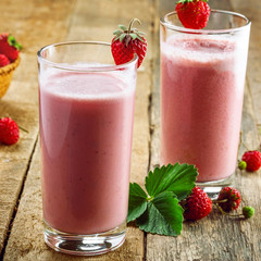 Delicious fruit milkshake made of fresh ripe strawberry and milk. Diet drink for healthy breakfast.