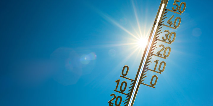 Rekordhitze, Thermometer mit strahlender Sonne und blauem Himmel im Hintergrund