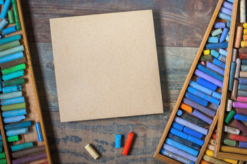 Colored pastel crayons and cardboard