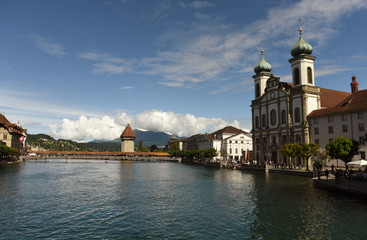 Lucerne cityscape, Switzerland. Jesuit Church and Chapel Bridge (Kapellbrucke) with Water Tower on...
