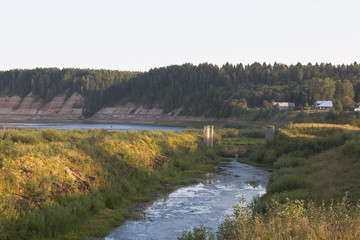 Remains of the Opokskogo hydroelectric complex in the rays of the setting sun. Village Threshold in...
