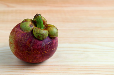 Ripe Purple Mangosteen Fruit on the Wooden Table, with Free Space for Design and Text