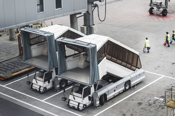 Airport service vehicles standby on airport tarmac