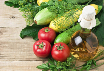 vegetables and  bottle of oil, still life on a wooden table
