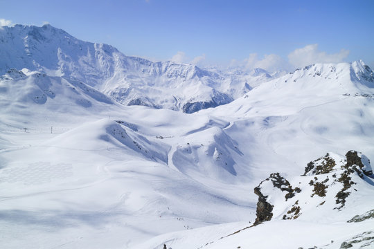 Alpine snowy peaks landscape with skiing slopes and lifts in Paradiski ski area, Alps, France