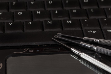 wrench tool and screwdrivers over a laptop