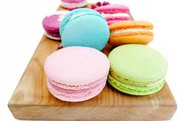 Gourmet macaron colorful cookies on wood desk. Isolated on white background