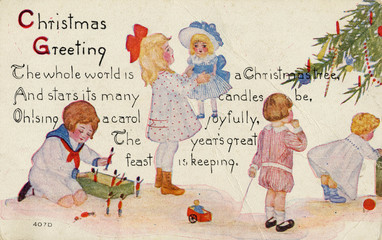 Children playing with their Christmas presents  c. 1910.. Date: circa 1910