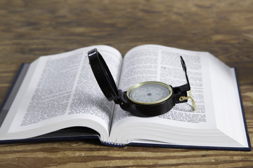A compass on an open Bible