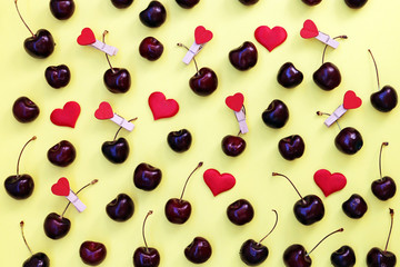 Naklejka na ściany i meble Fresh cherry berries on a yellow background