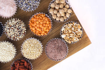 Fototapeta na wymiar Various superfoods, seeds, cereals, grains on a white background. Healthy eating concept. Flatlay
