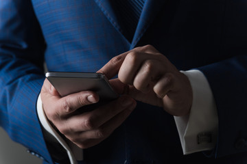 man using mobile phone or smartphone with hands