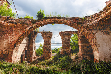 Fototapeta na wymiar Ruins of an ancient abandoned Orthodox temple or church of red brick with big Arches 