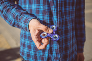 Man hand holding popular fidget spinner toy