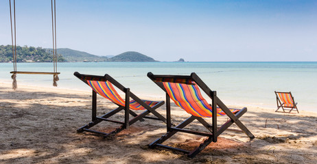 Beach chairs on tropical sand beach.