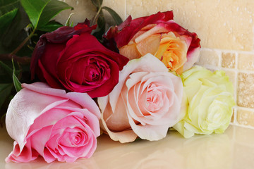 Bouquet of flowers from multi-colored roses. Five different-colored roses.
