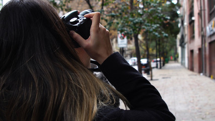 Young Woman Photographing a Urban Street