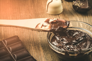 abundance of chocolate on a wooden background/abundance of chocolate on a wooden background. Toned
