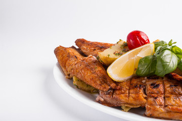 Grilled mackerel with lemon on a white background