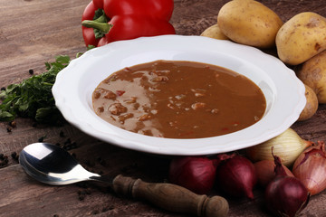 Tasty Hungarian beef goulash soup bograch close-up on the table and ingredient
