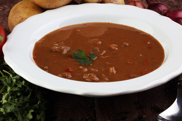 Tasty Hungarian beef goulash soup bograch close-up on the table and ingredient