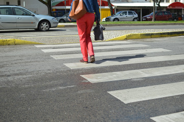 Woman walking zebra crossing outdoors background. Safe commuting sidewalk travel ransportation