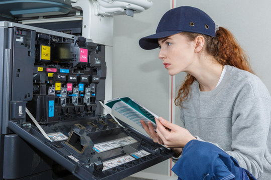 young woman performing toner change and printer maintenance
