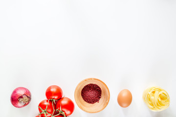 Preparing for cooking italian pasta white background top view copyspace