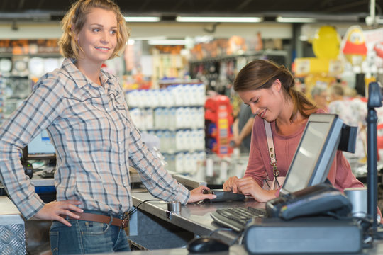 customer paying in harware shop using credit card terminal